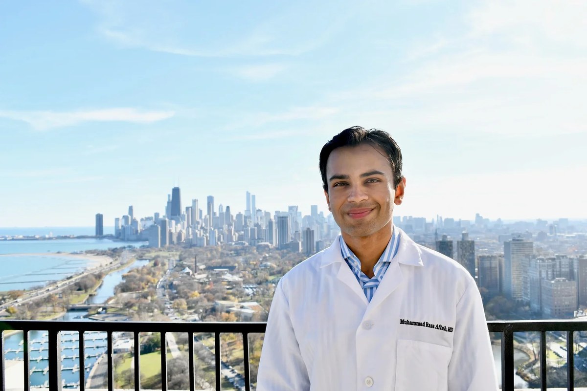 Dr. Muhammad Raza Aftab of Chicago Direct Primary Care with the Chicago skyline behind him