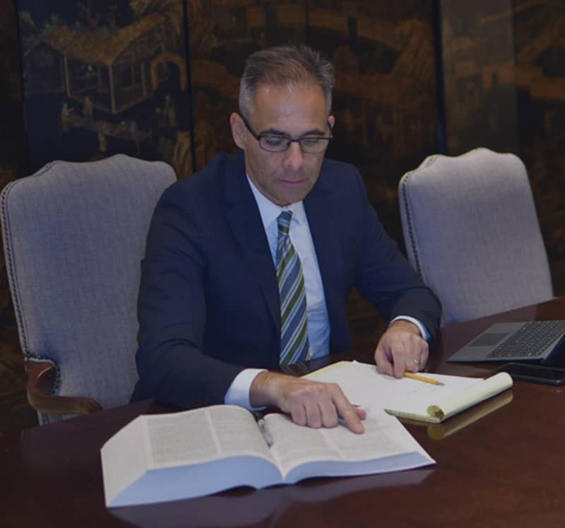 Phoenix personal injury attorney Luis P. Guerra reviewing case documents at his conference table